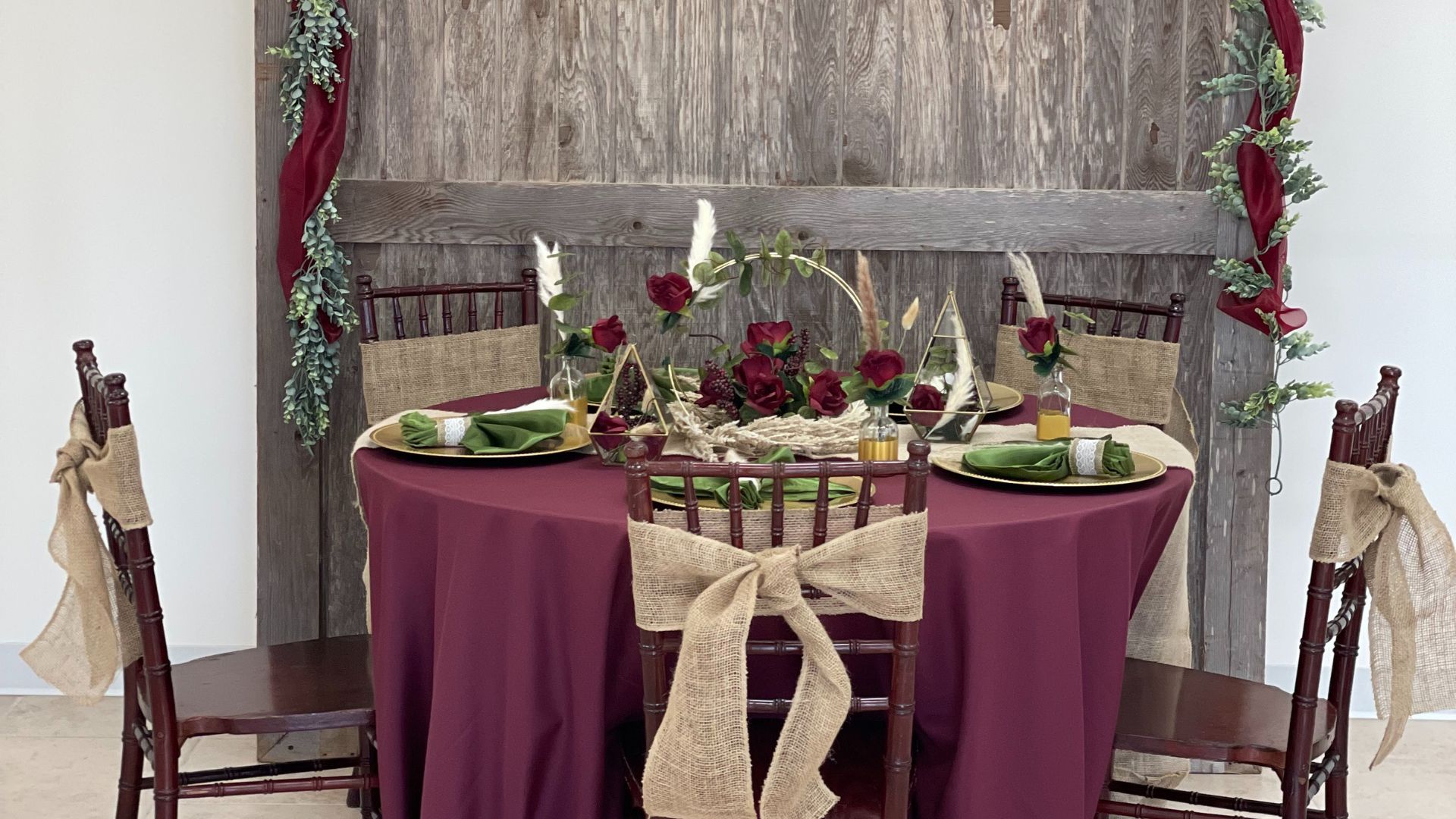 fall maroon and burlap tablescape with floral centerpieces and pampas grass