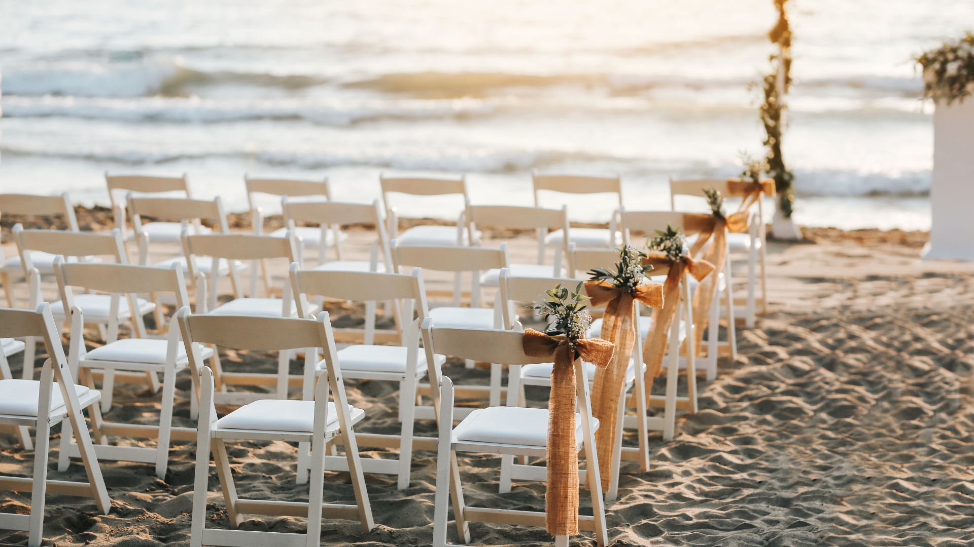 beach wedding white chairs gold sashes padre island mustang island