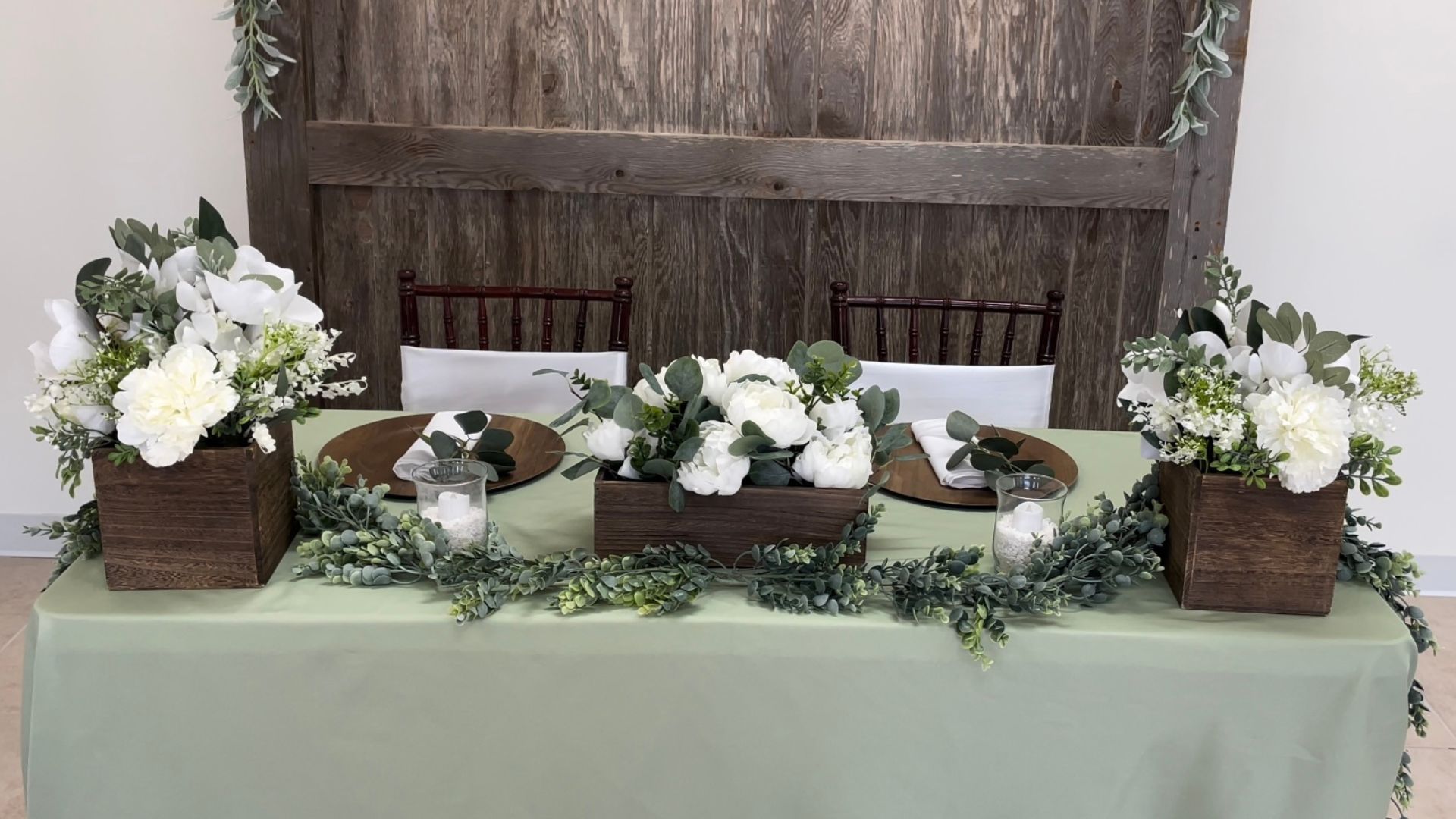 sweetheart table eucalyptus and sage green with wooden accents wedding reception