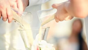 Sand pouring ceremony at beach wedding